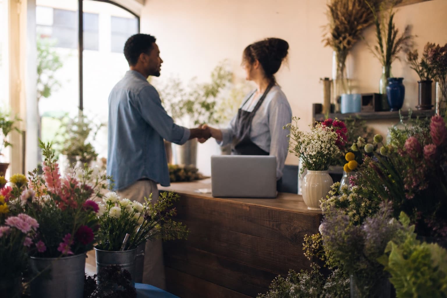 A sales partner closing a deal with a flower shop owner